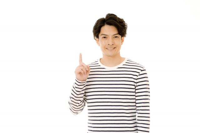 人差し指を立てる男性